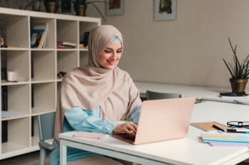 young-pretty-modern-muslim-woman-hijab-working-laptop-office-room-education-online