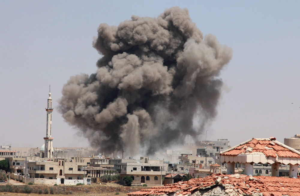 ارتفاع الدخان بعد غارات جوية لطائرات بشار الأسد على مدينة درعا (رويترز)