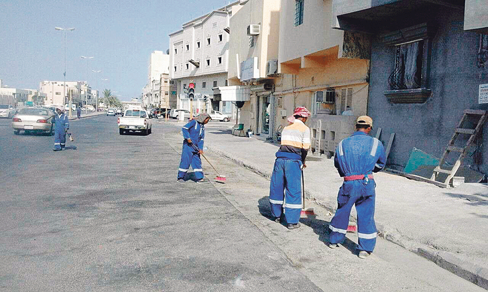 عمال البلدية يؤدون عملهم في نظافة الشوارع (اليوم)